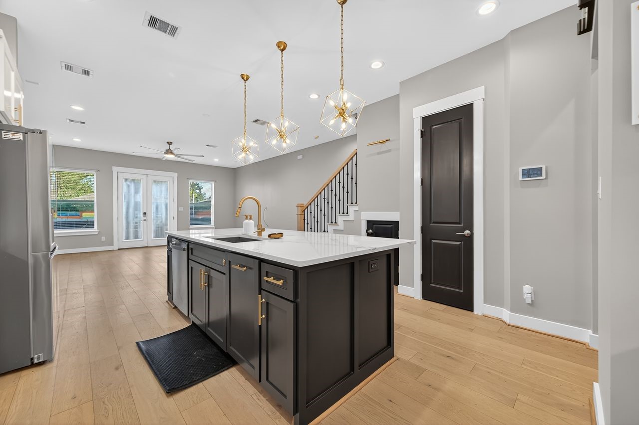 4508 Hardy Street, Unit B Houston, TX 77009 - Photo 9 of 40 a kitchen with kitchen island a sink a stove a refrigerator and a cabinets