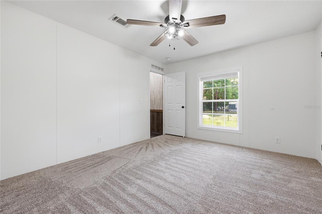 215 Southwest Alpine Place High Springs, FL 32643 - Photo 27 of 41 an empty room with windows and fan