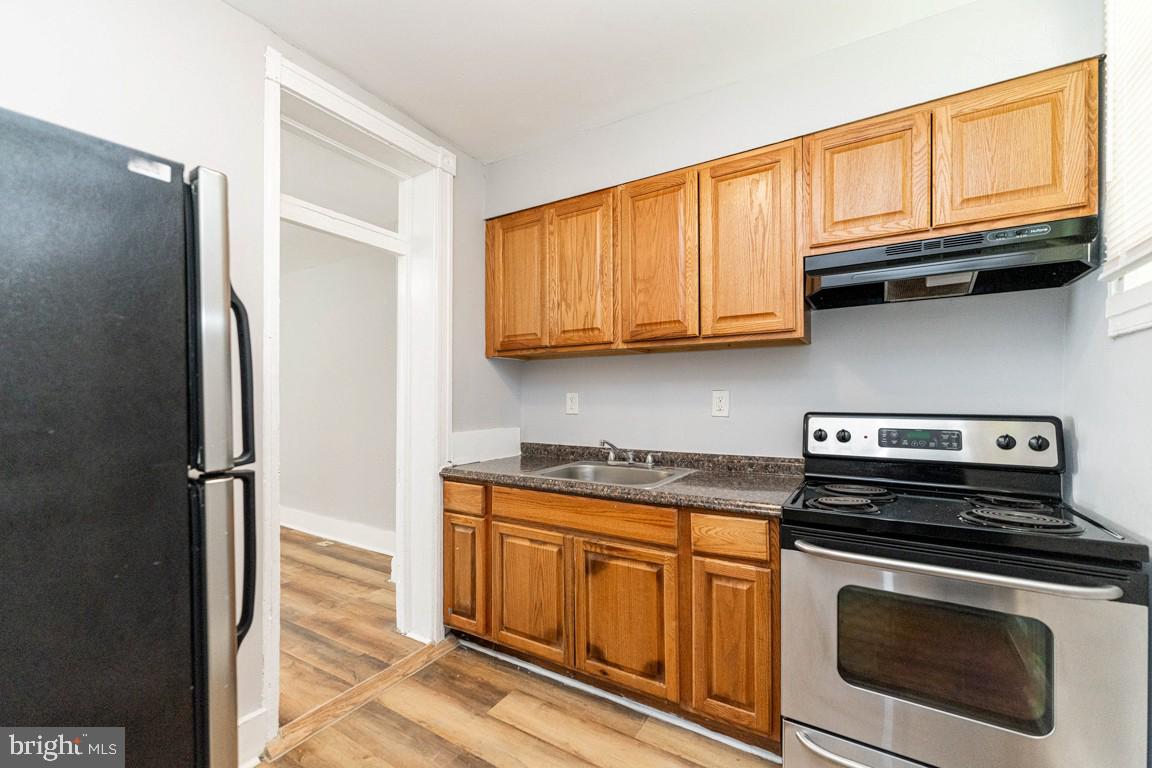 3006 Mathews Street Baltimore, MD 21218 - Photo 12 of 25 a kitchen with stainless steel appliances granite countertop a refrigerator stove and cabinets