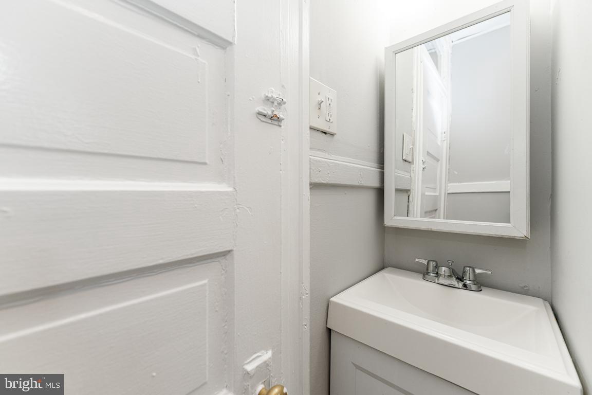 3006 Mathews Street Baltimore, MD 21218 - Photo 17 of 25 a bathroom with a sink a toilet and shower