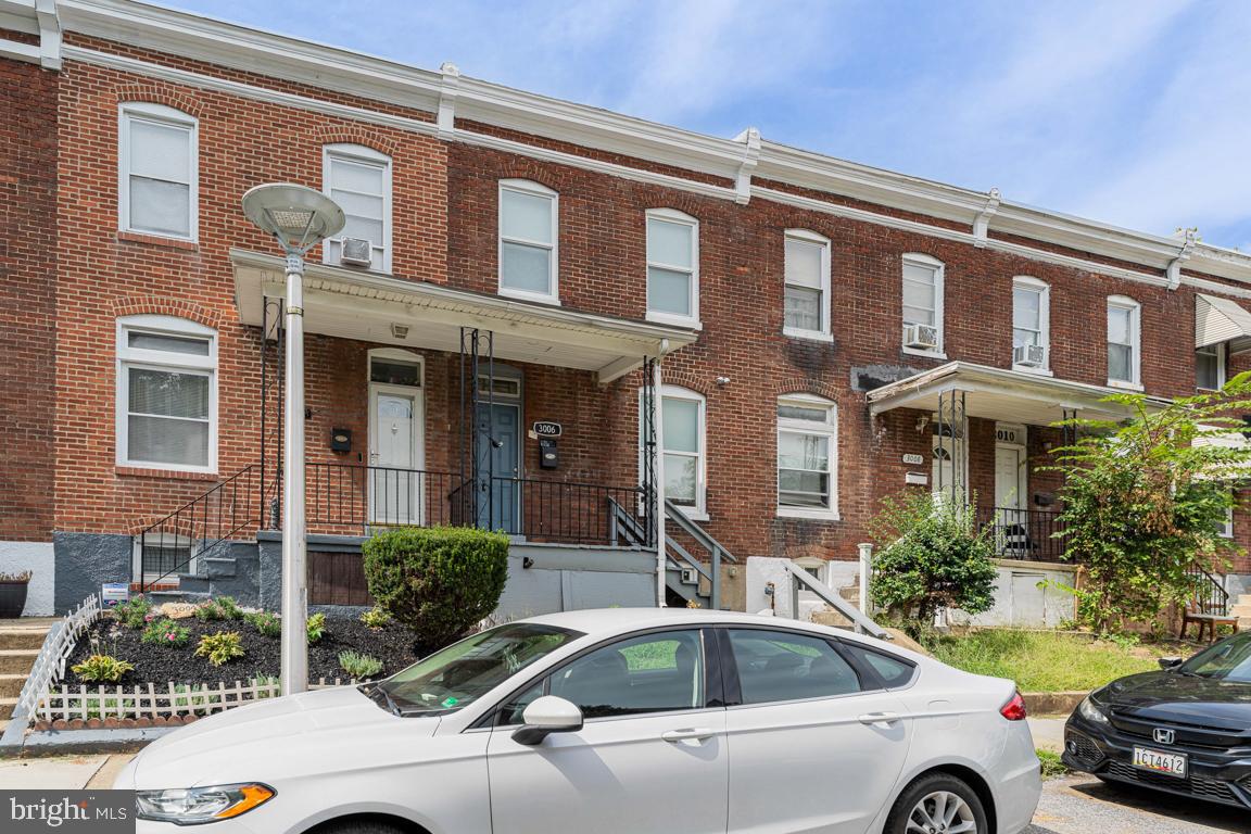 3006 Mathews Street Baltimore, MD 21218 - Photo 3 of 25 a front view of a house with car parked