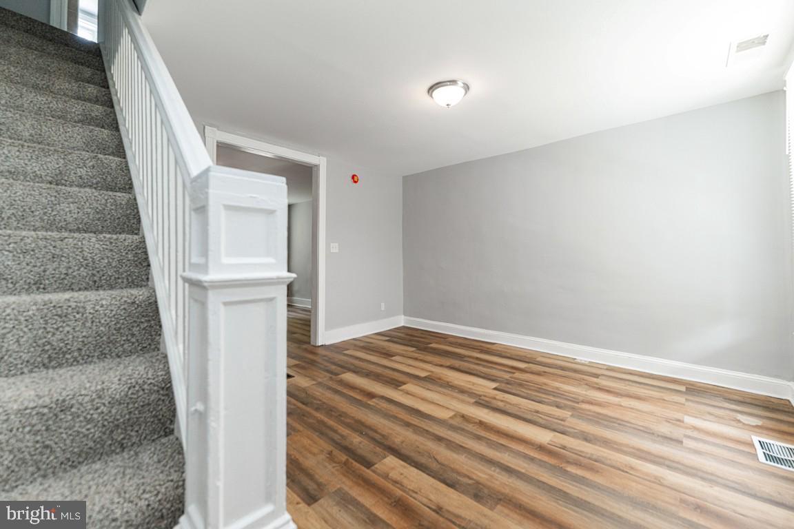 3006 Mathews Street Baltimore, MD 21218 - Photo 6 of 25 a view of empty room with wooden floor