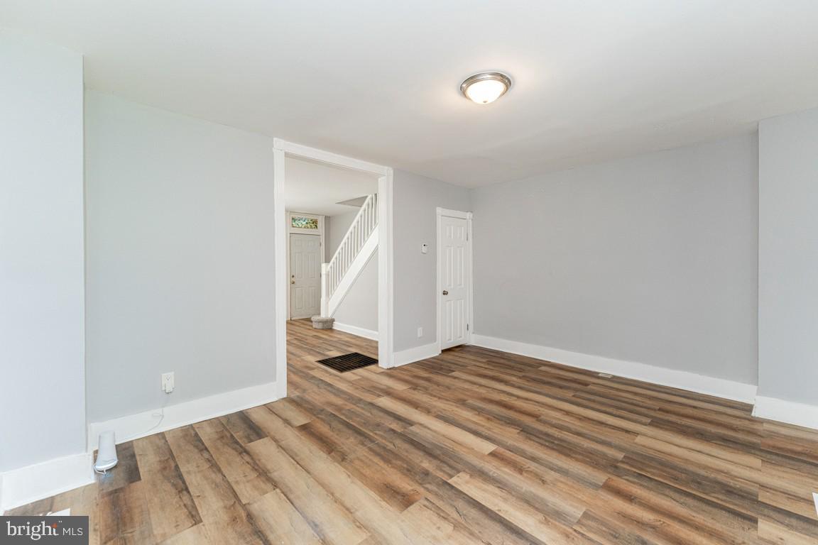 3006 Mathews Street Baltimore, MD 21218 - Photo 8 of 25 a view of a room with wooden floor and a ceiling fan