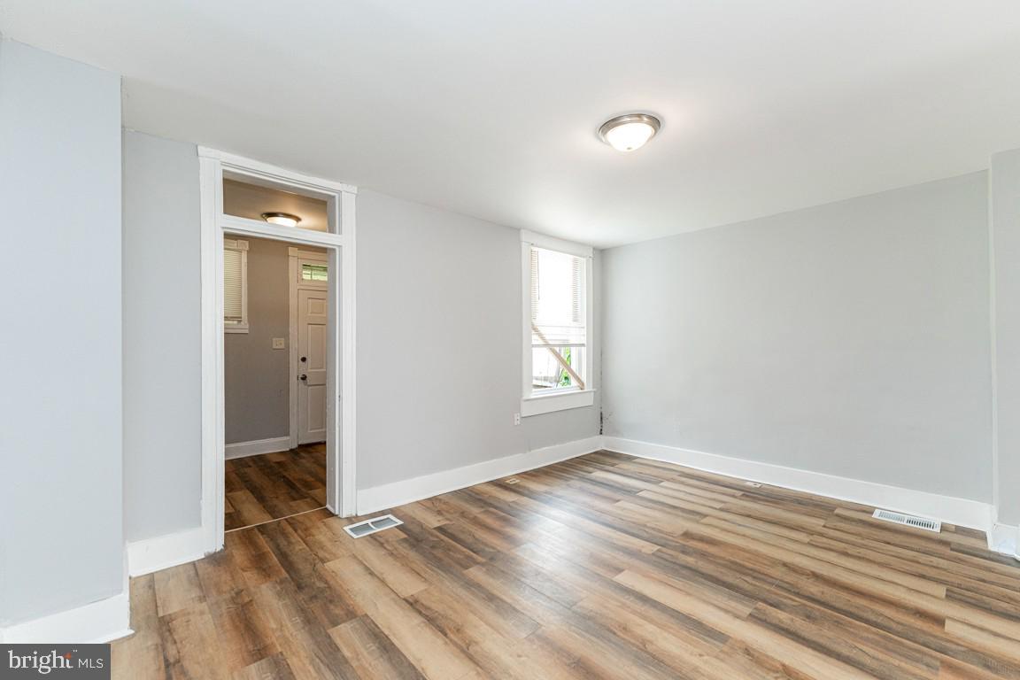3006 Mathews Street Baltimore, MD 21218 - Photo 9 of 25 a view of room with window and wooden floor