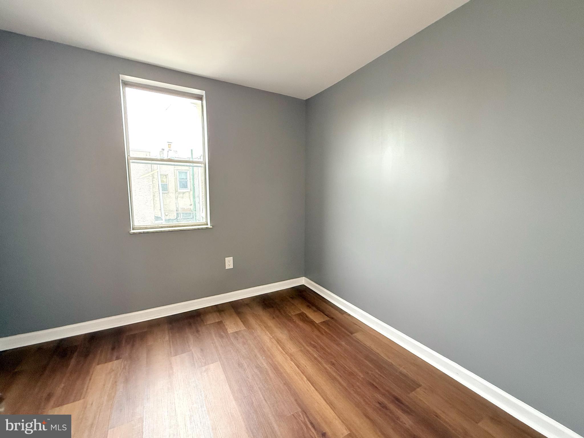 1114 Mercy Street Philadelphia, PA 19148 - Photo 24 of 35 an empty room with wooden floor and windows