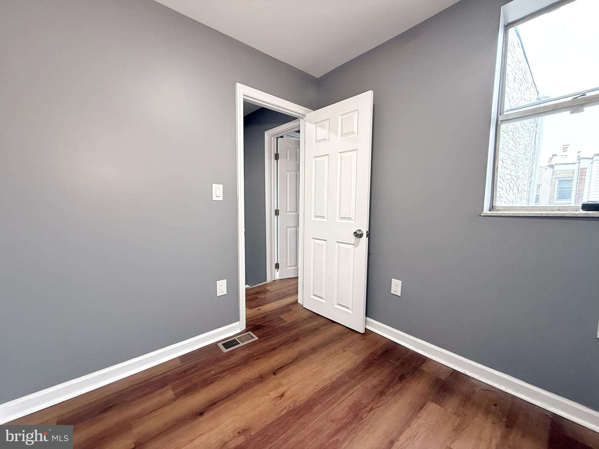 1114 Mercy Street Philadelphia, PA 19148 - Photo 28 of 35 an empty room with wooden floor and windows