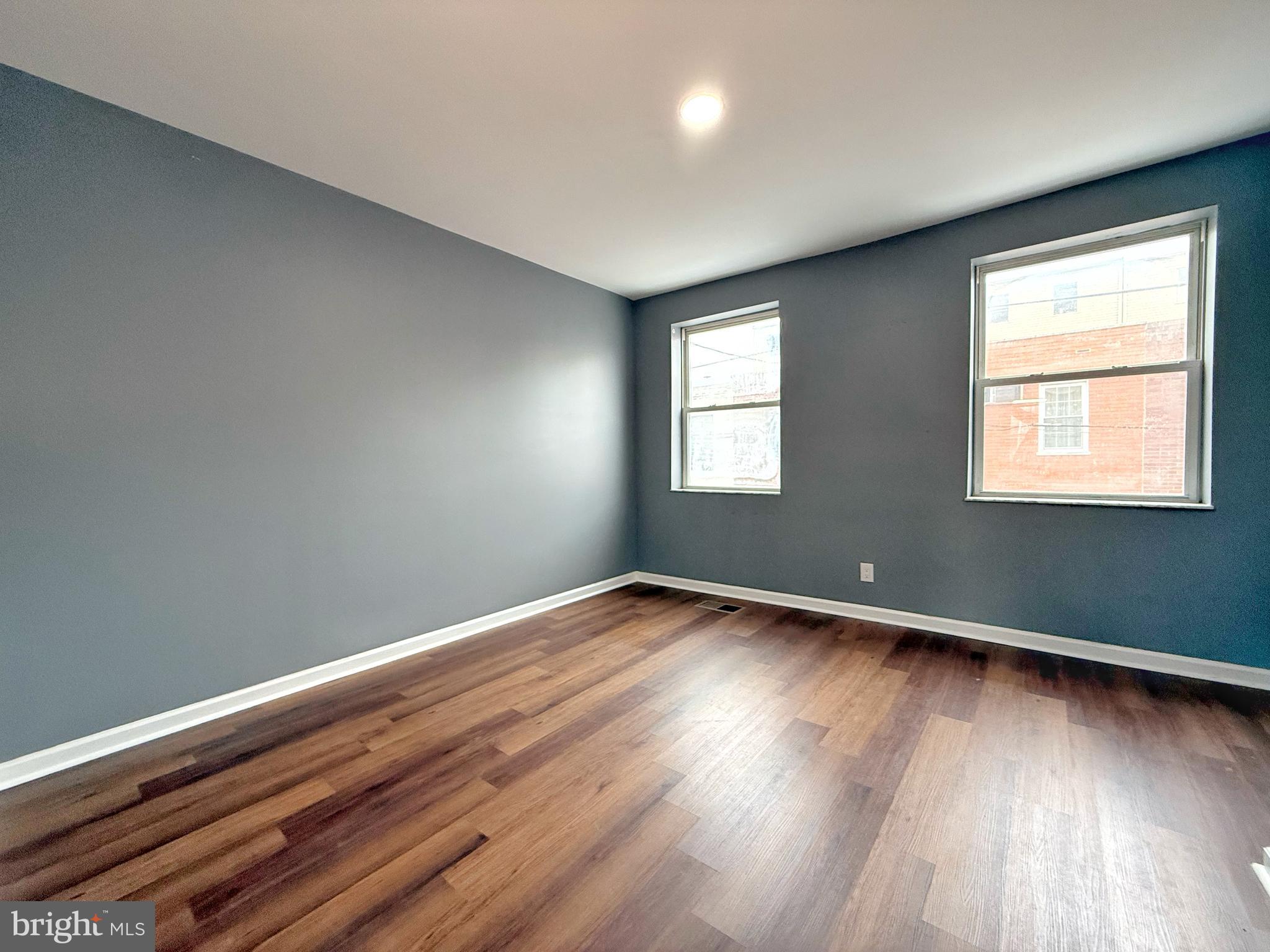 1114 Mercy Street Philadelphia, PA 19148 - Photo 29 of 35 a view of an empty room with wooden floor and a window