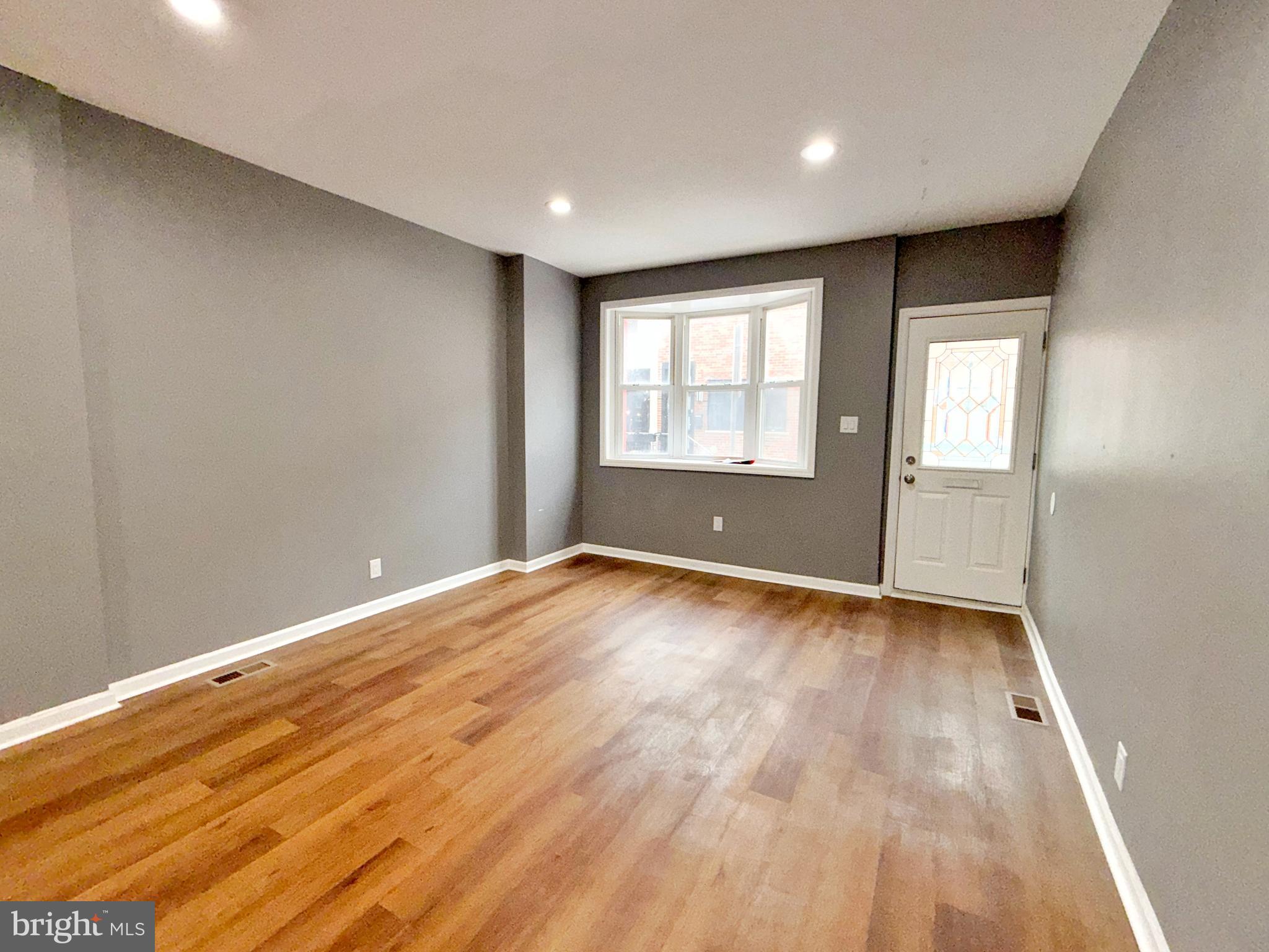 1114 Mercy Street Philadelphia, PA 19148 - Photo 35 of 35 an empty room with wooden floor and windows