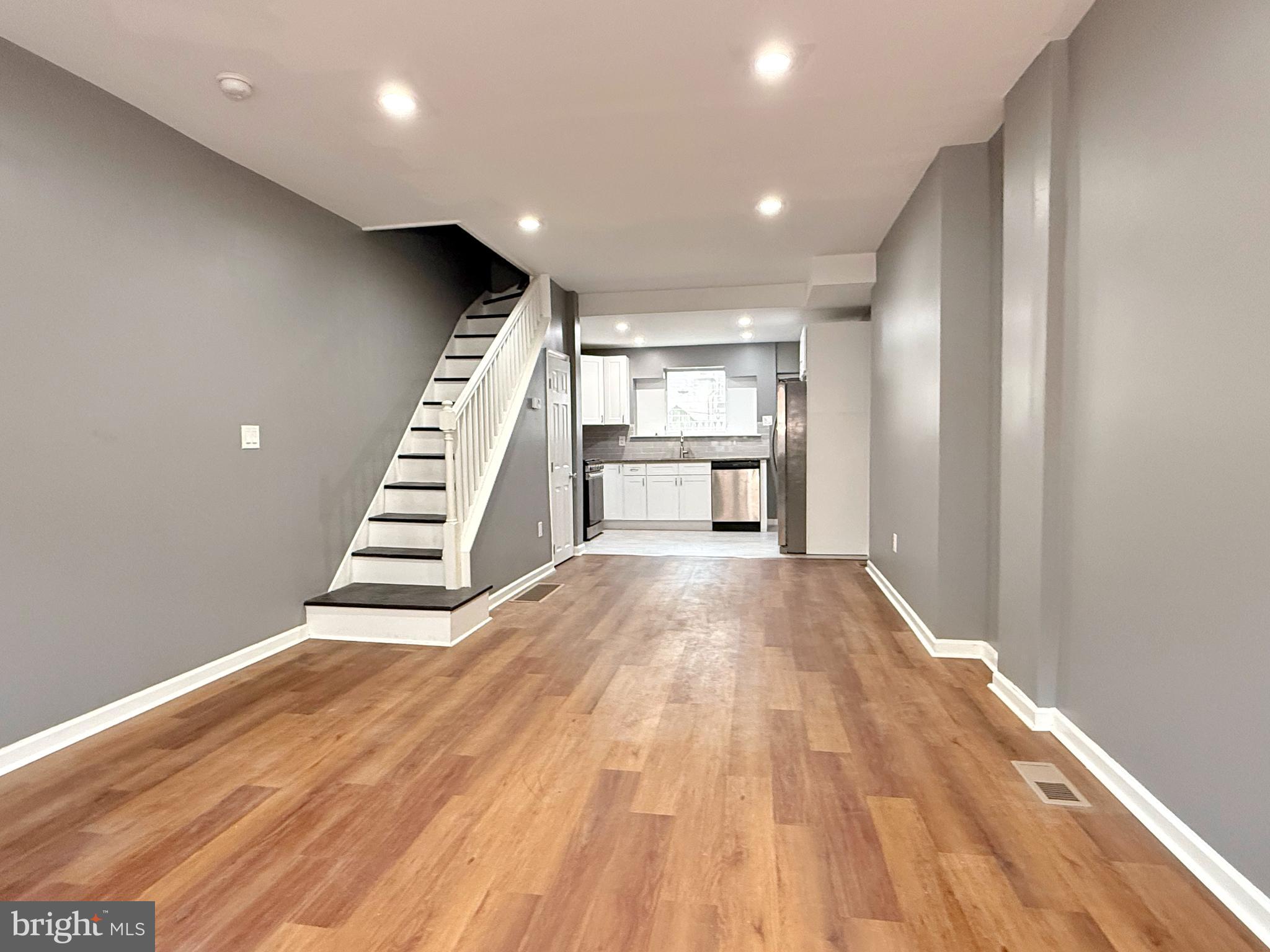 1114 Mercy Street Philadelphia, PA 19148 - Photo 4 of 35 a view of kitchen and empty room with wooden floor