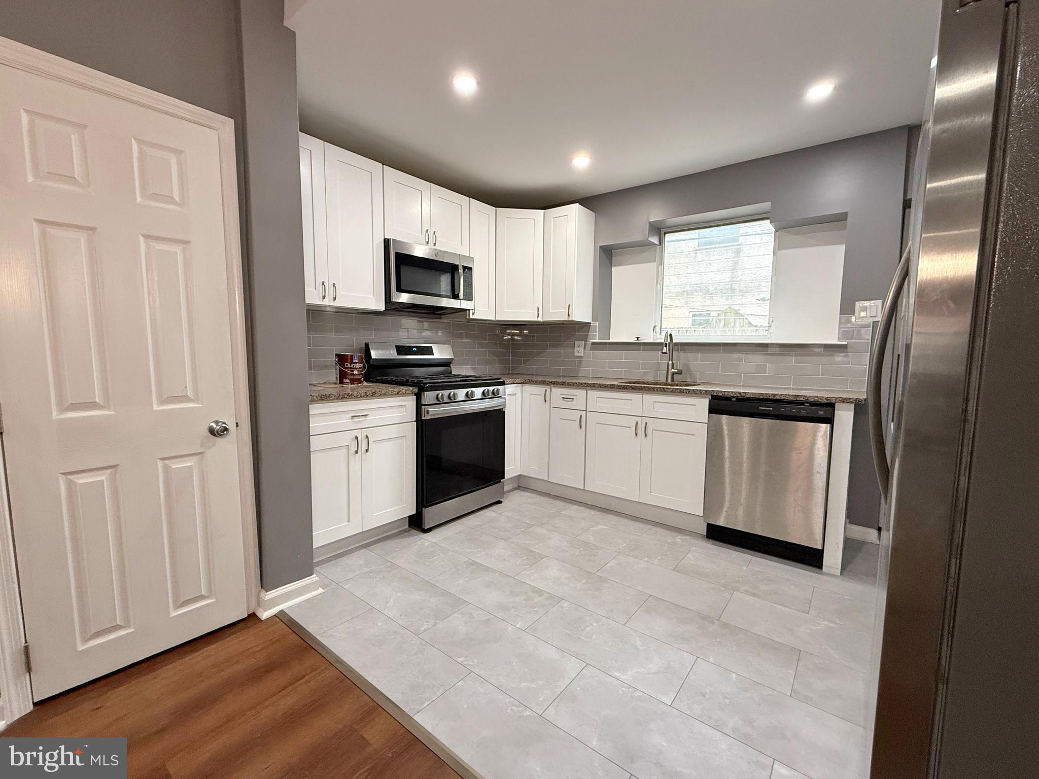 1114 Mercy Street Philadelphia, PA 19148 - Photo 6 of 35 a kitchen with stainless steel appliances granite countertop a stove sink and cabinets