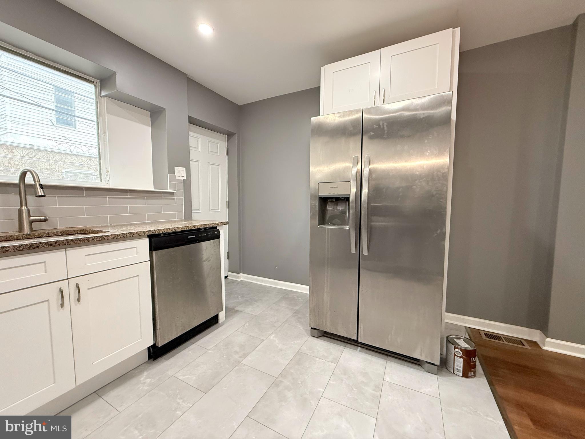 1114 Mercy Street Philadelphia, PA 19148 - Photo 10 of 35 a kitchen with a sink and refrigerator