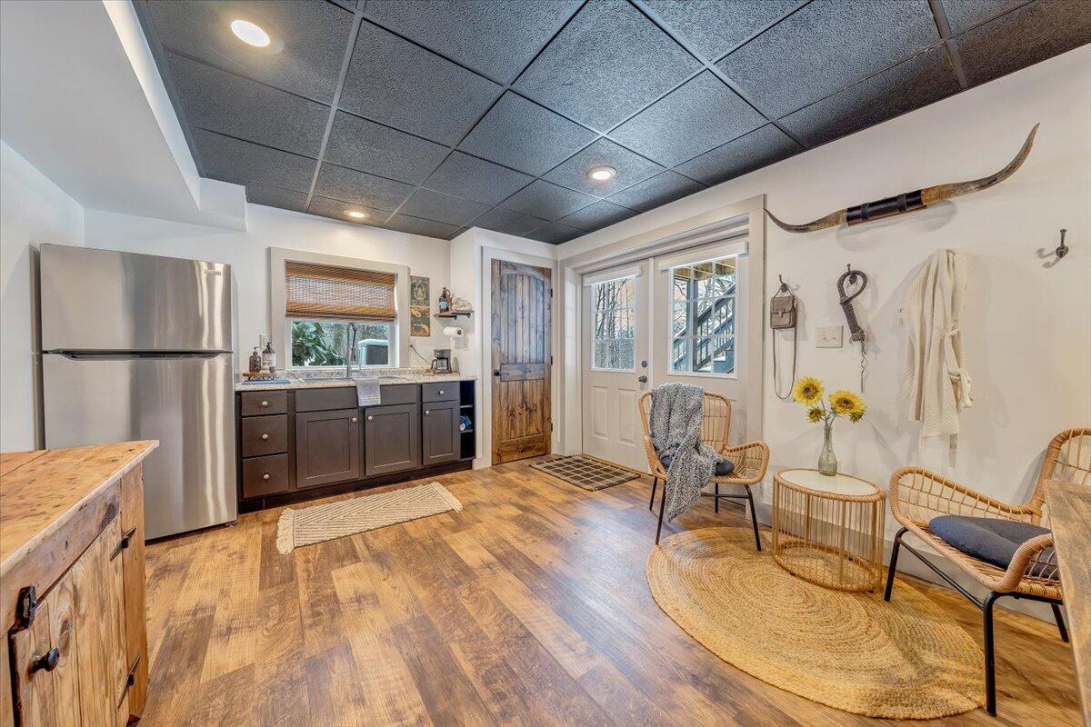 3851 Joppa Mill Road Moneta, VA 24121 - Photo 92 of 104 a kitchen with stainless steel appliances granite countertop a refrigerator a sink dishwasher a dining table and chairs with wooden floor
