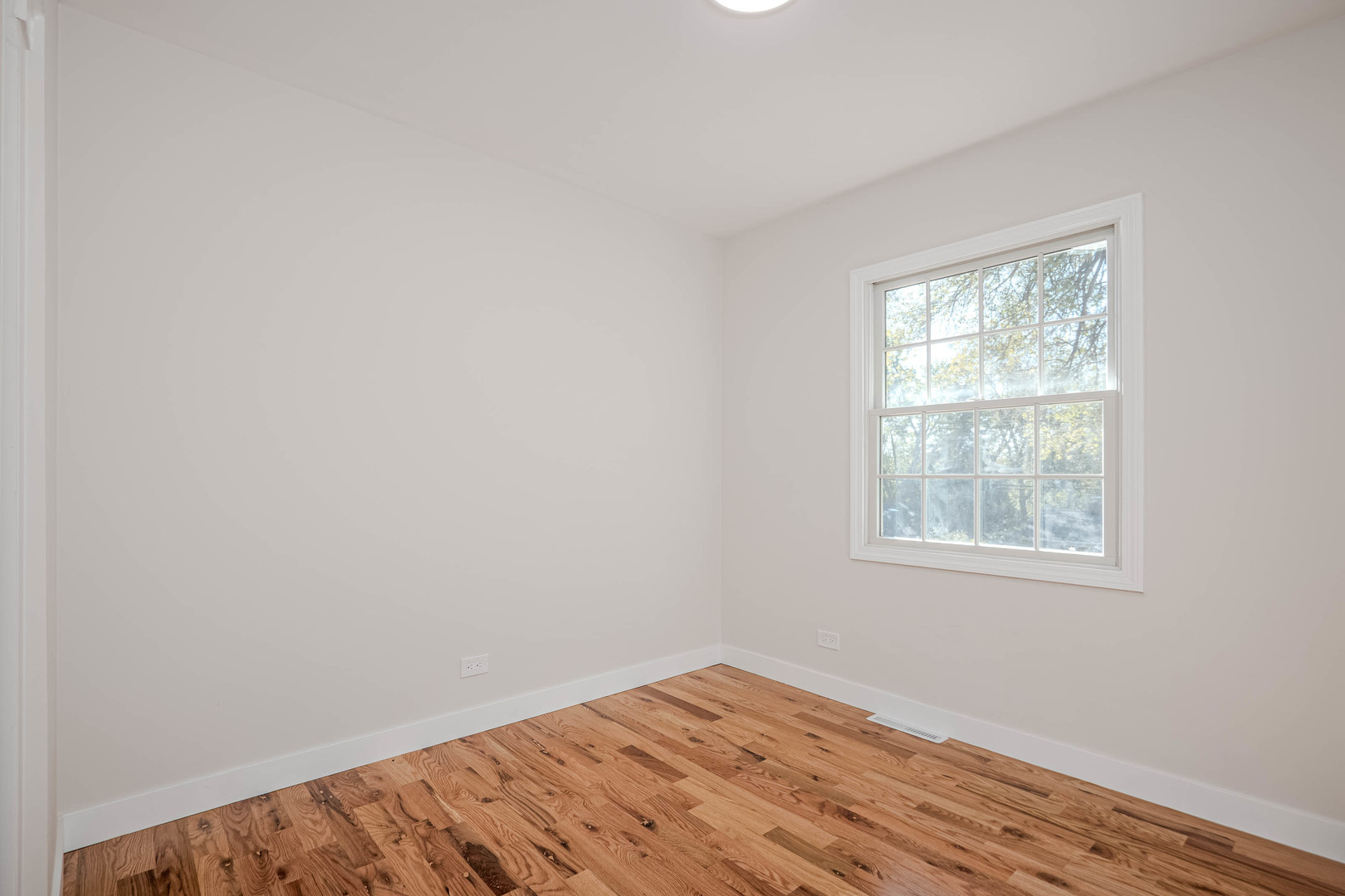 839 North Bennett Street Geneva, IL 60134 - Photo 17 of 33 an empty room with wooden floor and a window