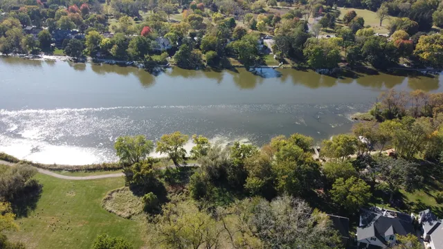 an aerial view of a house with swimming pool and outdoor seating