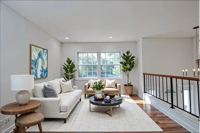 a living room with furniture and a potted plant