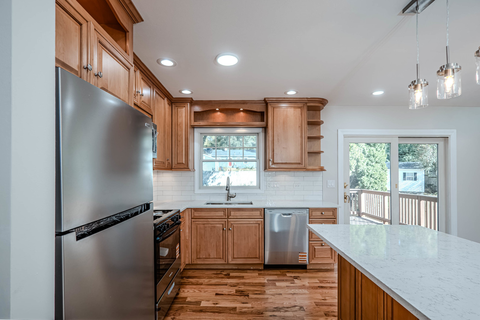 839 North Bennett Street Geneva, IL 60134 - Photo 8 of 33 a kitchen with stainless steel appliances granite countertop a refrigerator a sink dishwasher a stove and white countertops with wooden floor