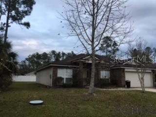 28 Riverside Lane Palm Coast, FL 32164 - Photo 1 of 1 a front view of a house with garden