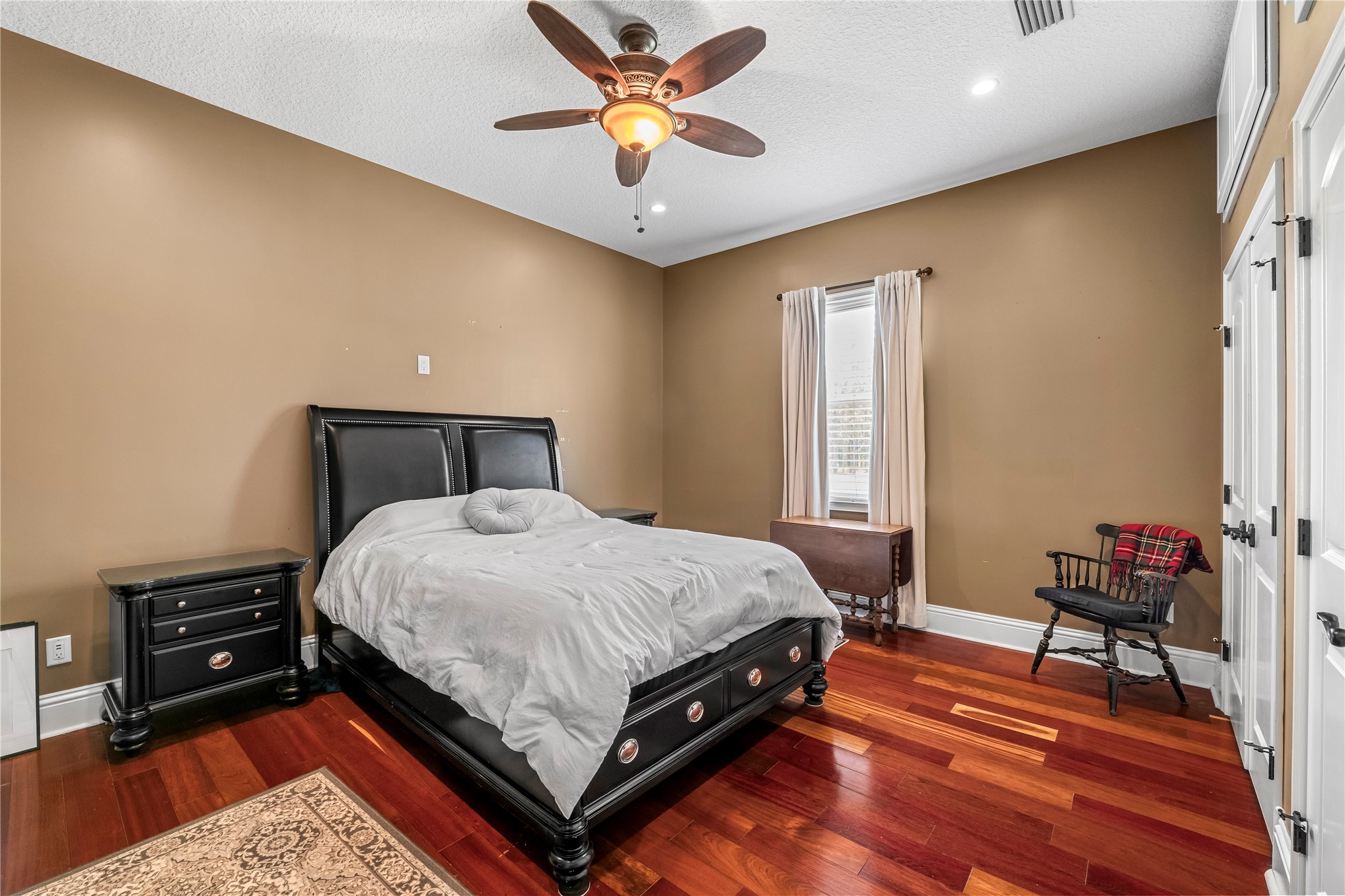 27247 Hallman Road Hilliard, FL 32046 - Photo 43 of 59 a bedroom with a bed and a chandelier