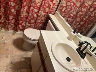 133 South Jackson Street, Unit A6 Denver, CO 80209 - Photo 16 of 19 a bathroom with a sink toilet and mirror