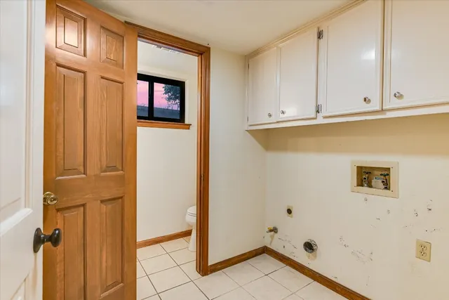 a view of a kitchen with white cabinets