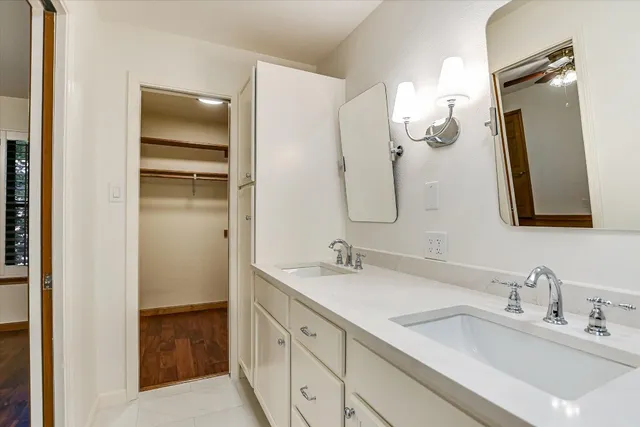 a bathroom with a double vanity sink and mirror