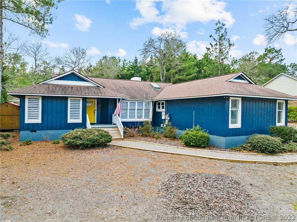 680 Burning Tree Road Pinehurst, NC 28374 - Photo 1 of 43 a front view of a house with a yard and garage