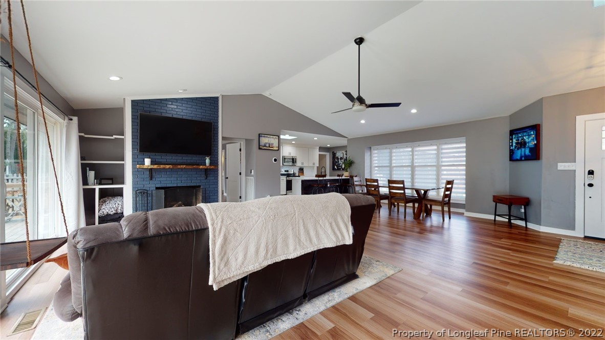 680 Burning Tree Road Pinehurst, NC 28374 - Photo 12 of 43 a living room with fireplace furniture and a flat screen tv