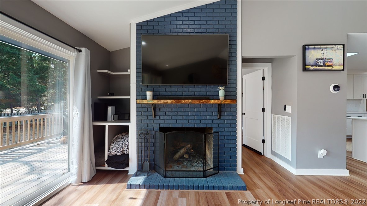 680 Burning Tree Road Pinehurst, NC 28374 - Photo 13 of 43 a living room with furniture and a fireplace