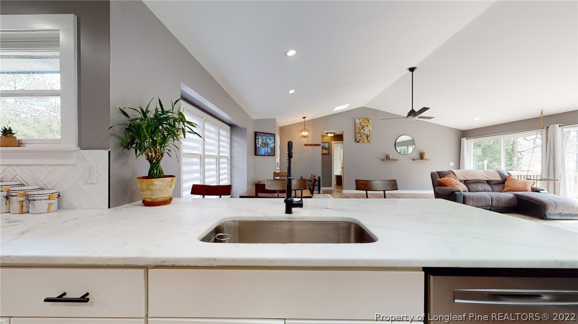 680 Burning Tree Road Pinehurst, NC 28374 - Photo 20 of 43 a kitchen with stainless steel appliances a sink a counter top space cabinets and a window