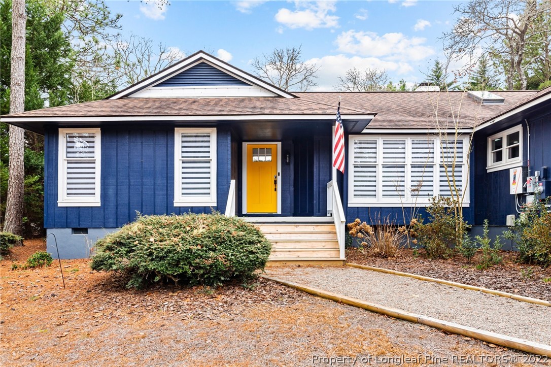 680 Burning Tree Road Pinehurst, NC 28374 - Photo 2 of 43 a front view of a house with a yard and garage