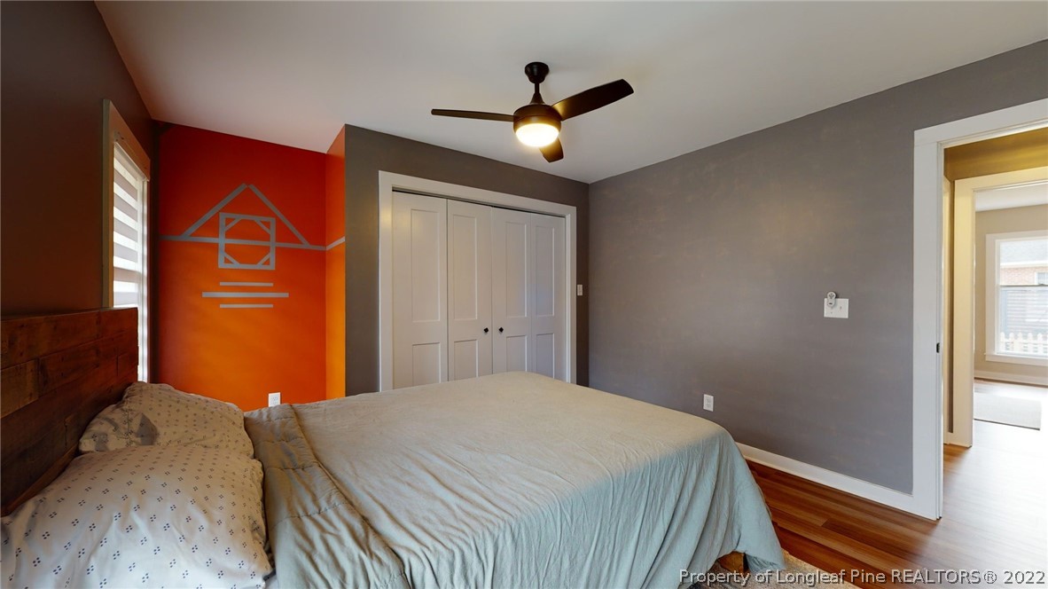 680 Burning Tree Road Pinehurst, NC 28374 - Photo 24 of 43 a bedroom with a bed and a chandelier