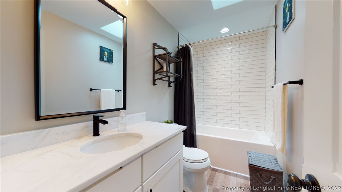 680 Burning Tree Road Pinehurst, NC 28374 - Photo 25 of 43 a bathroom with a sink toilet and shower