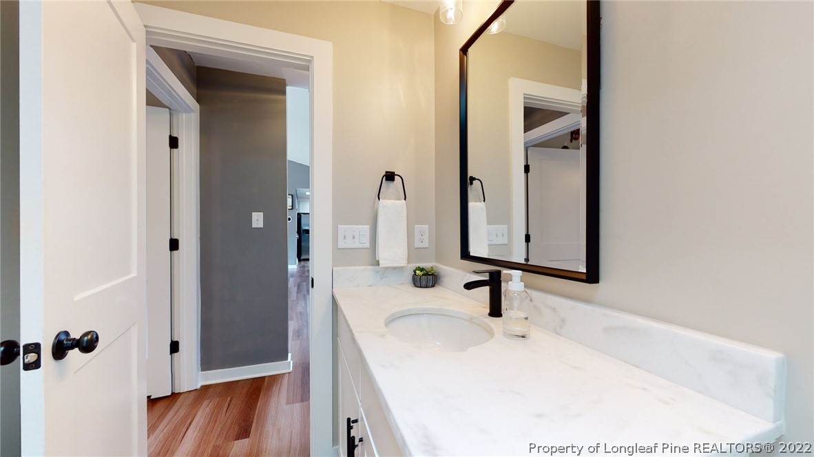 680 Burning Tree Road Pinehurst, NC 28374 - Photo 26 of 43 a bathroom with a sink and a mirror