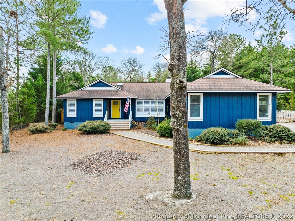 680 Burning Tree Road Pinehurst, NC 28374 - Photo 3 of 43 a front view of a house with a garden