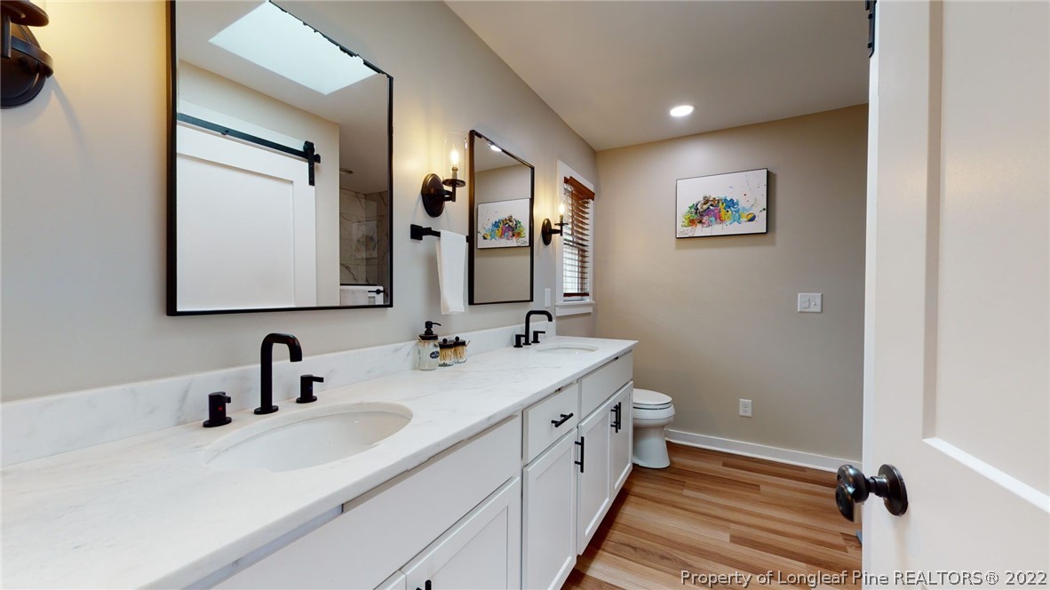 680 Burning Tree Road Pinehurst, NC 28374 - Photo 31 of 43 a bathroom with a double vanity sink mirror and toilet