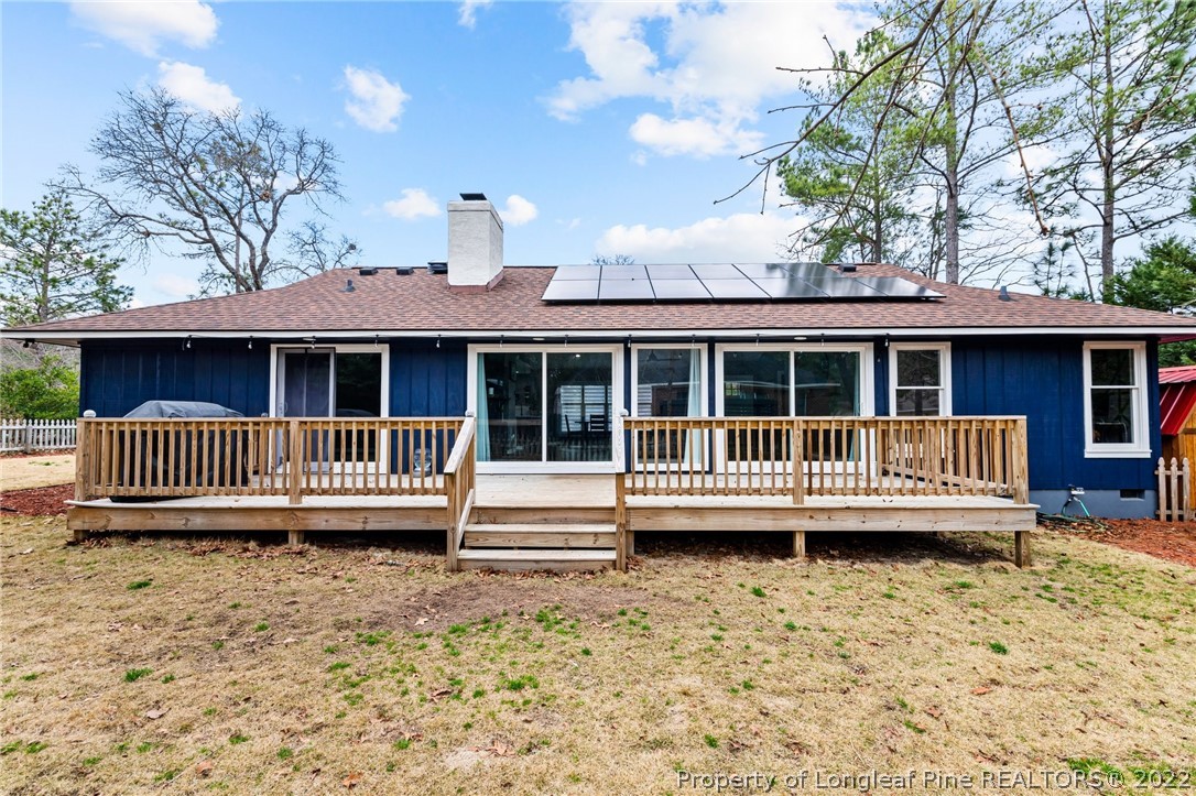 680 Burning Tree Road Pinehurst, NC 28374 - Photo 37 of 43 a view of a house with a wooden deck and a yard