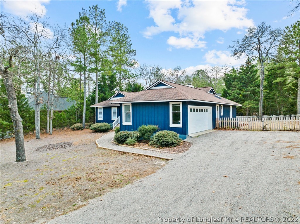 680 Burning Tree Road Pinehurst, NC 28374 - Photo 4 of 43 a front view of a house with a yard and potted plants