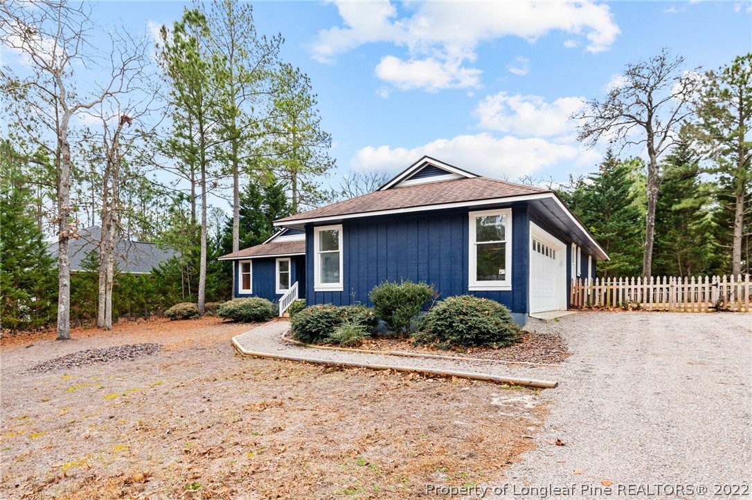 680 Burning Tree Road Pinehurst, NC 28374 - Photo 9 of 43 a front view of a house with a yard