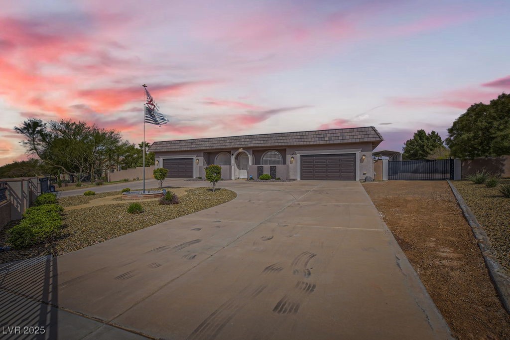 647 Foxhall Road Henderson, NV 89002 - Photo 51 of 82 View of front of home featuring fence, driveway, a gate, and an attached garage