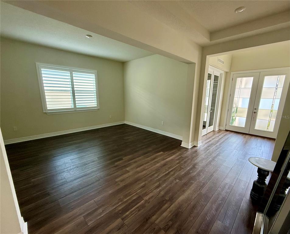 8441 Pk Clf Way Orlando, FL 32836 - Photo 8 of 59 a view of an empty room with wooden floor and a window