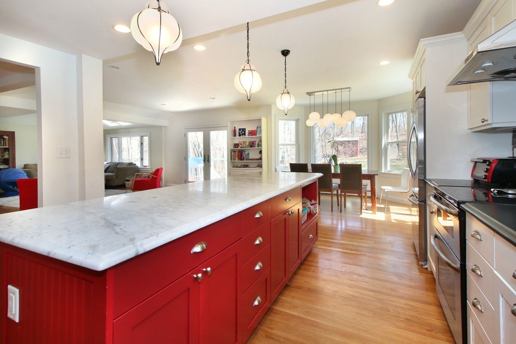 a large kitchen with lots of counter space and chandelier