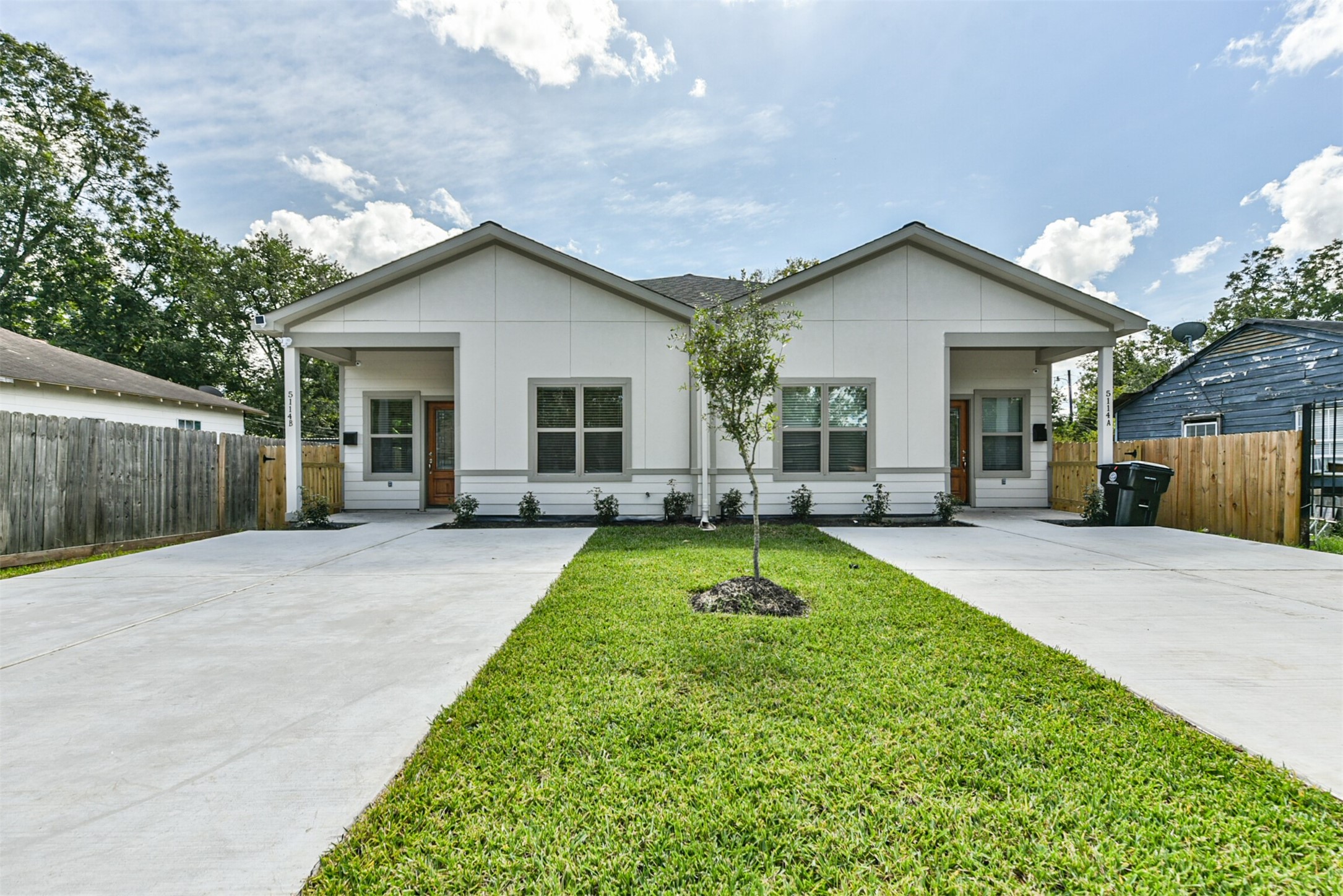 a view of a house with backyard and porch