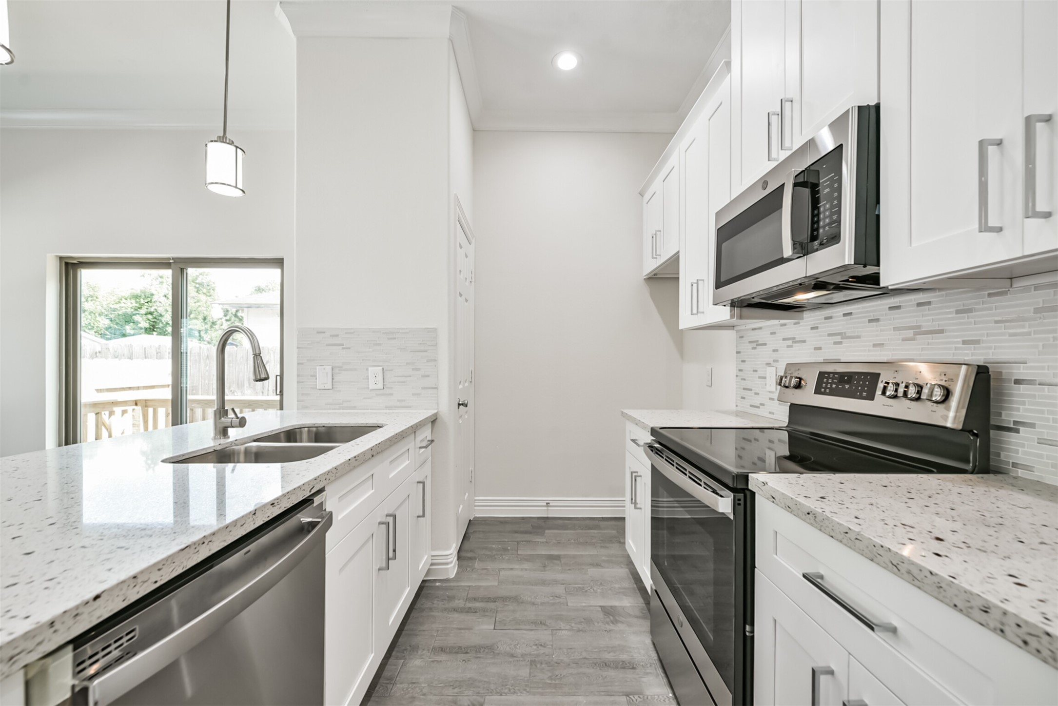 5114 Higgins Street, Unit A Houston, TX 77033 - Photo 10 of 28 a kitchen with stainless steel appliances granite countertop a sink and a stove