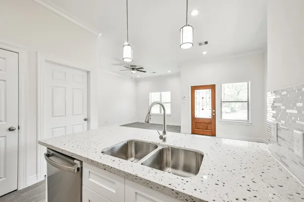 a kitchen with stainless steel appliances granite countertop a sink and a stove