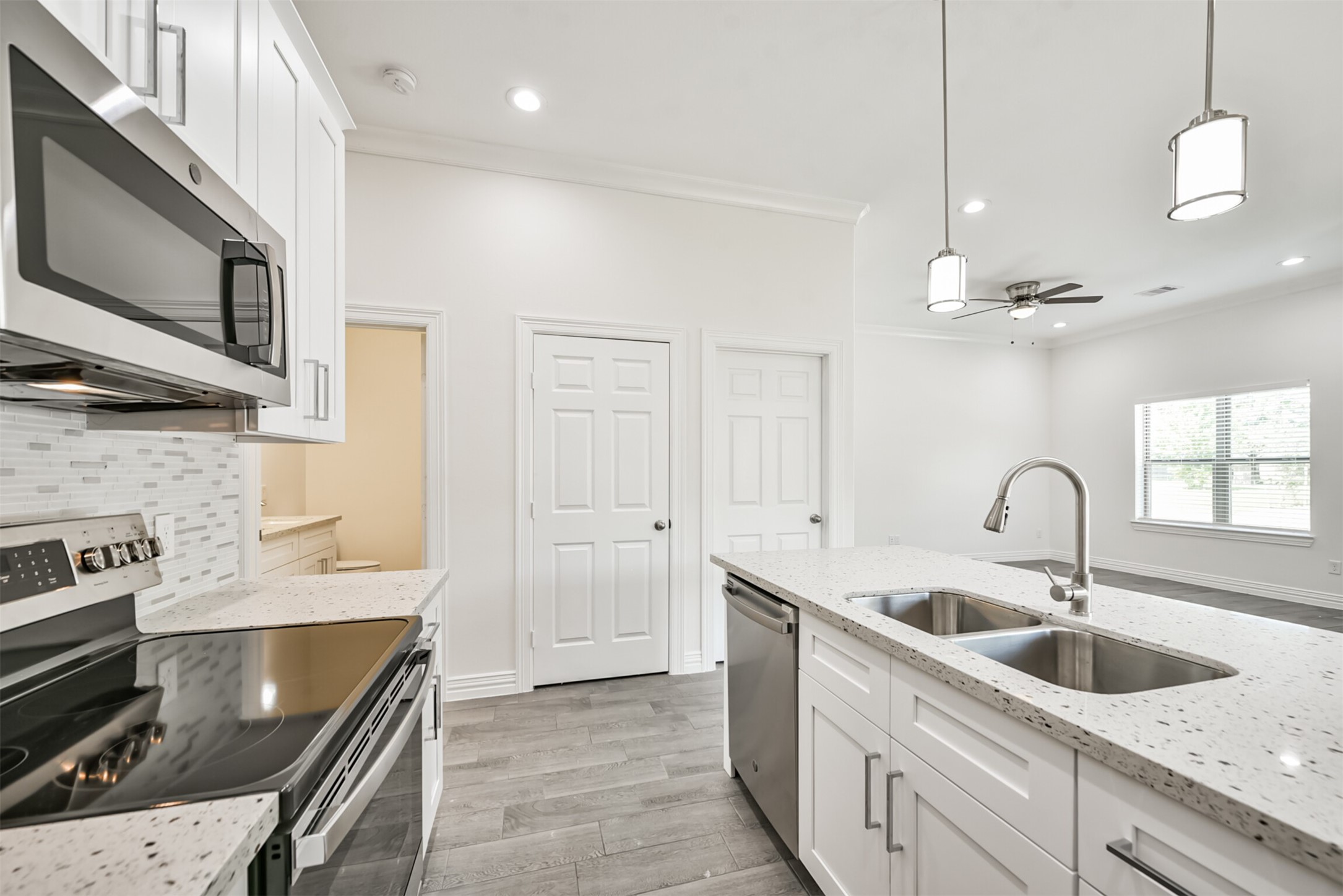 5114 Higgins Street, Unit A Houston, TX 77033 - Photo 12 of 28 a kitchen with a sink a stove and cabinets