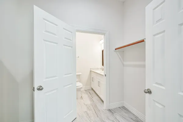 an empty room with ceiling fan and entryway