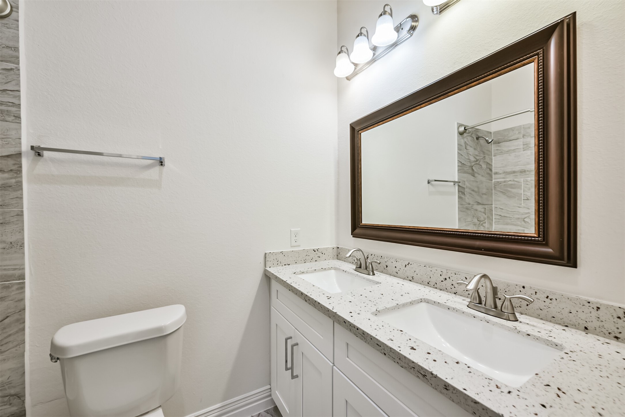 5114 Higgins Street, Unit A Houston, TX 77033 - Photo 17 of 28 a bathroom with a granite countertop sink mirror vanity and toilet