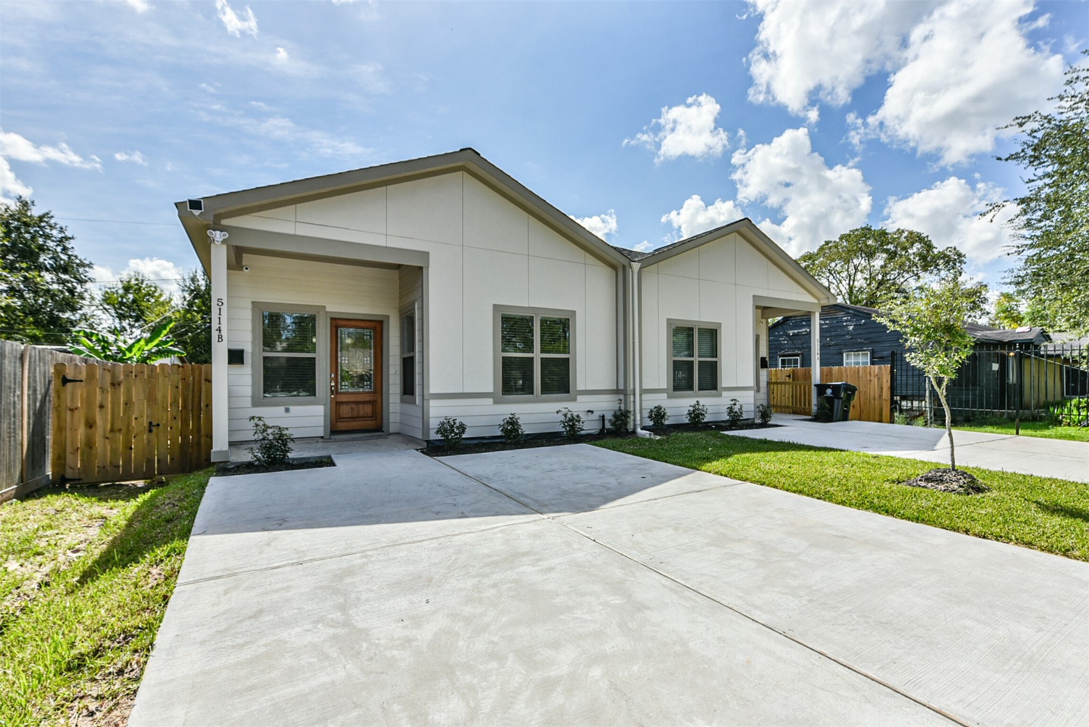 5114 Higgins Street, Unit A Houston, TX 77033 - Photo 2 of 28 a front view of a house with a yard and garage