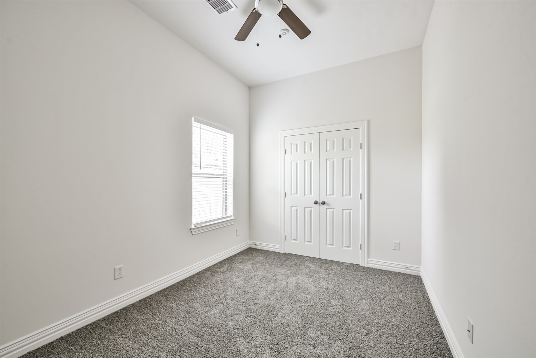 5114 Higgins Street, Unit A Houston, TX 77033 - Photo 20 of 28 an empty room with windows and fan