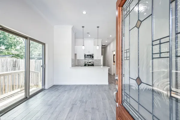 a view of a hallway view with wooden floor and windows
